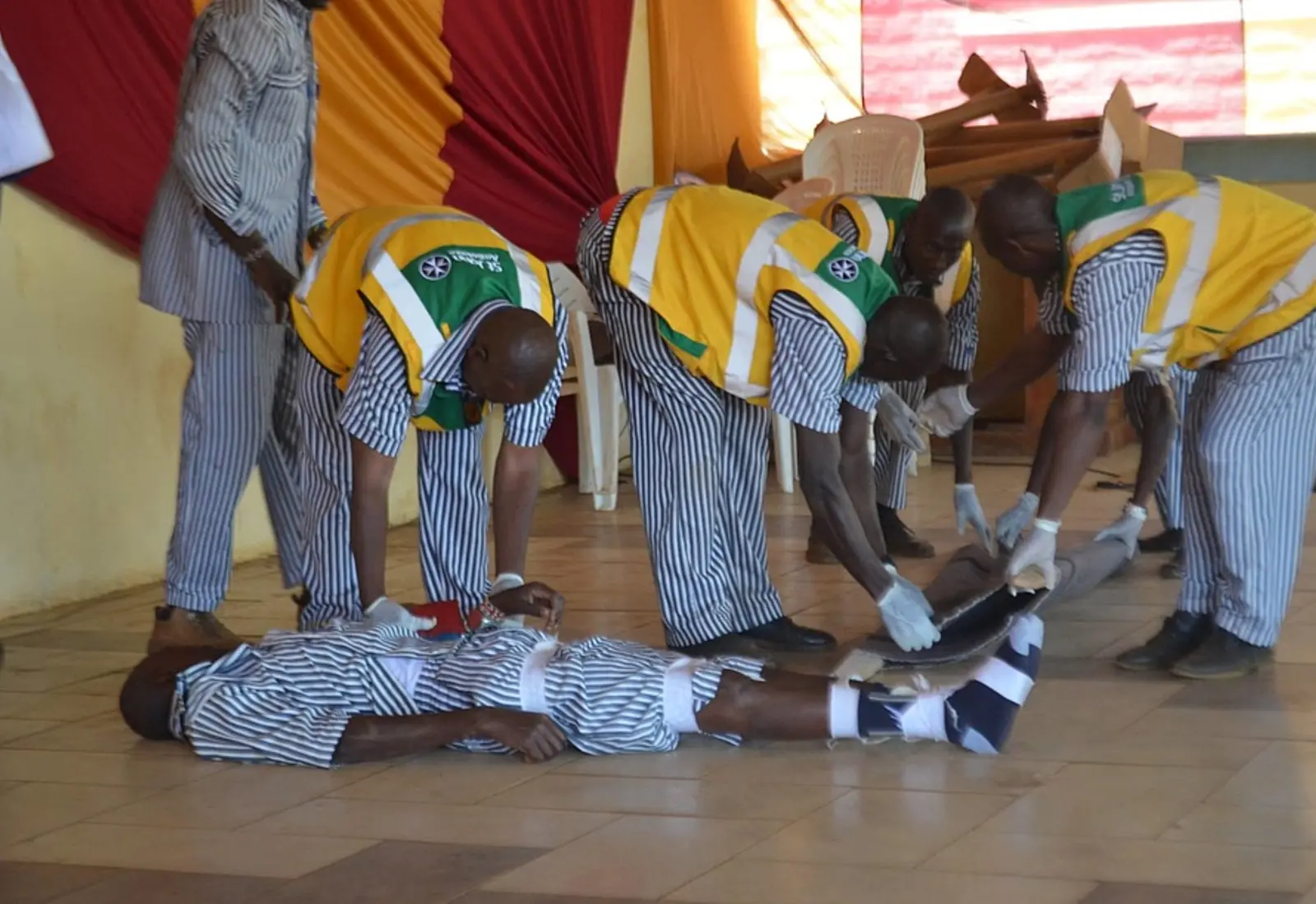 Participants demonstrating first aid skills at a graduation ceremony